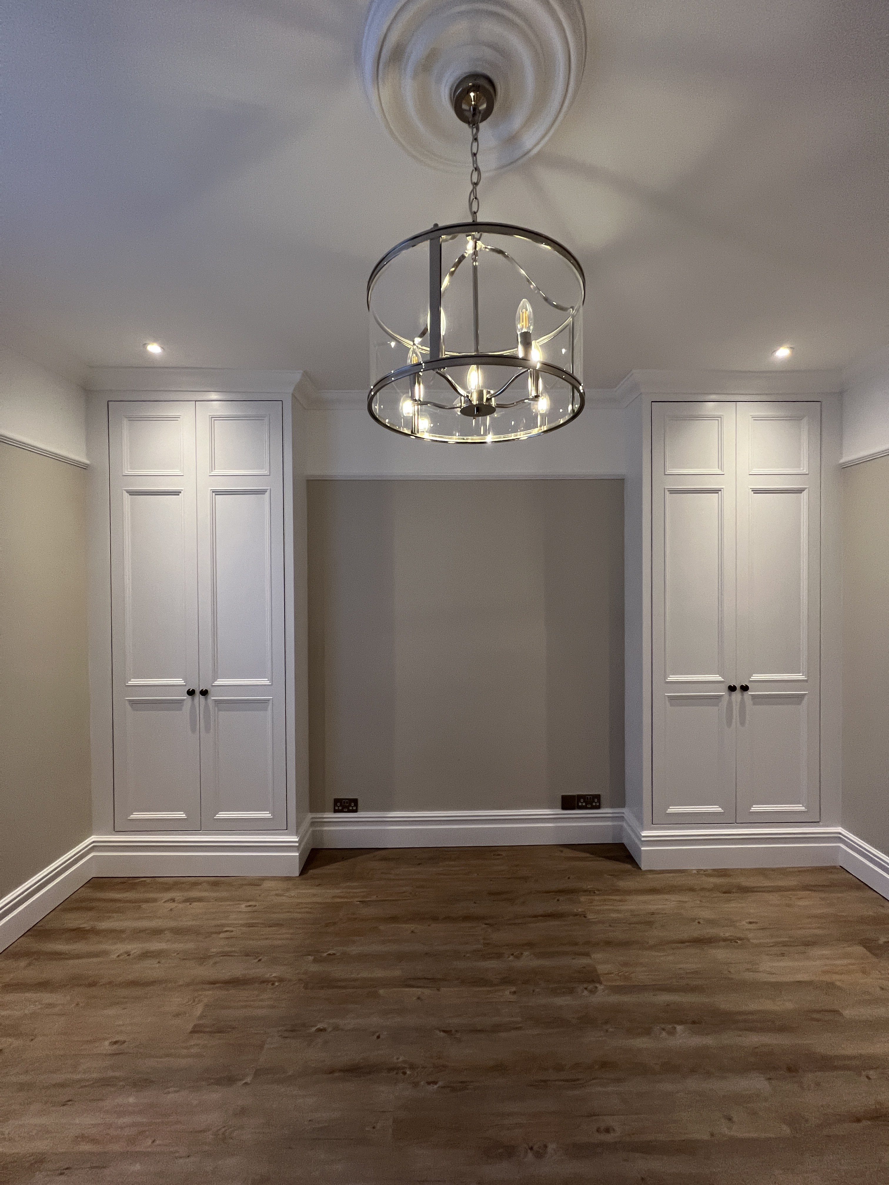 Bespoke white fitted alcove storage with pendant lantern