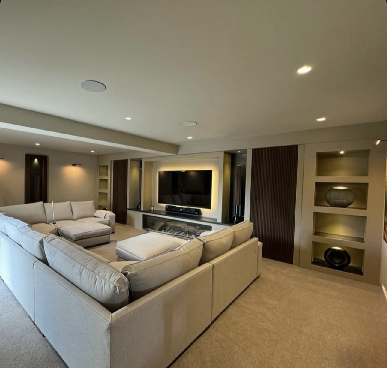 Bespoke cinema room with built-in media wall and feature lighting