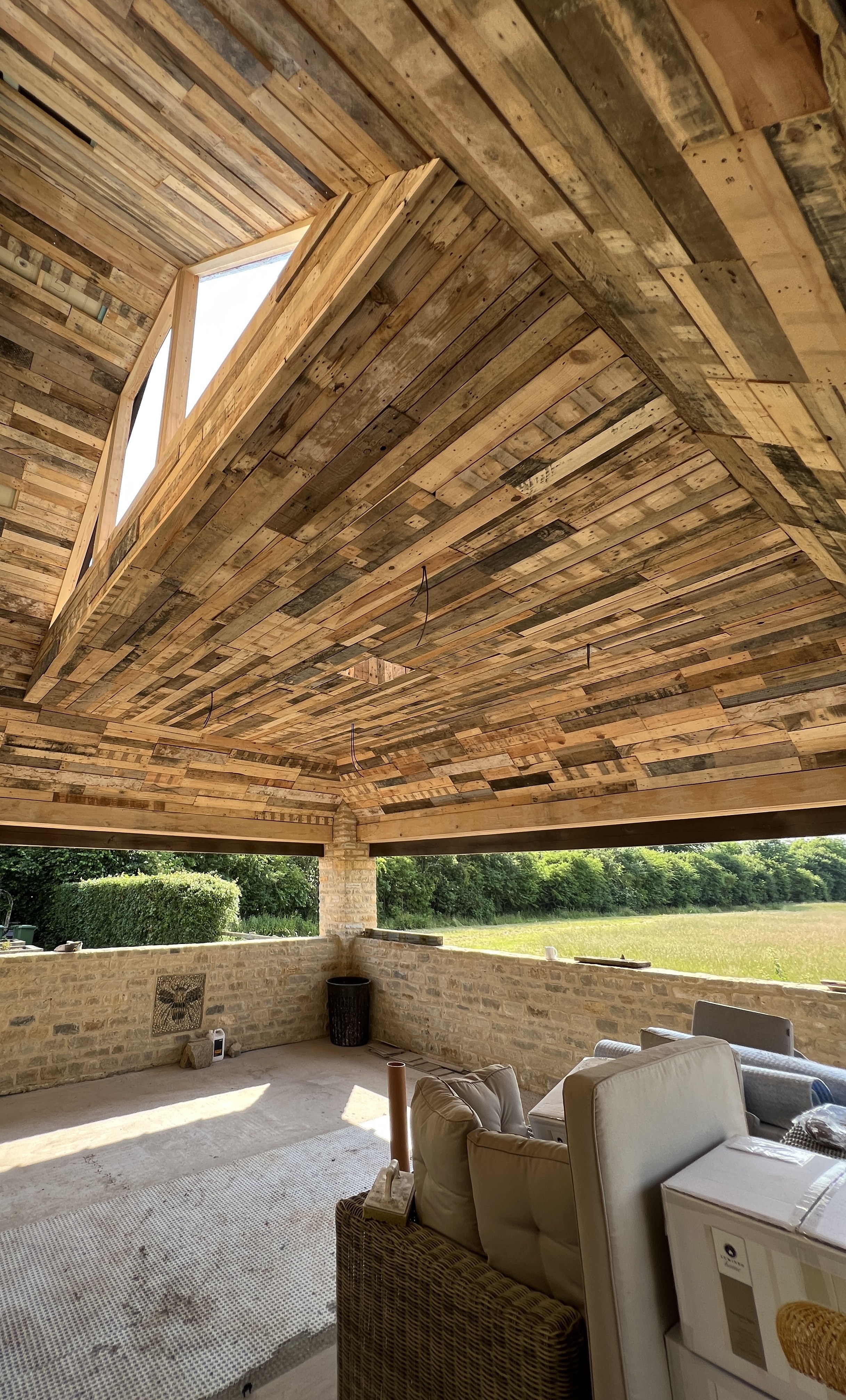Bespoke garden room interior with reclaimed pallet timber ceiling